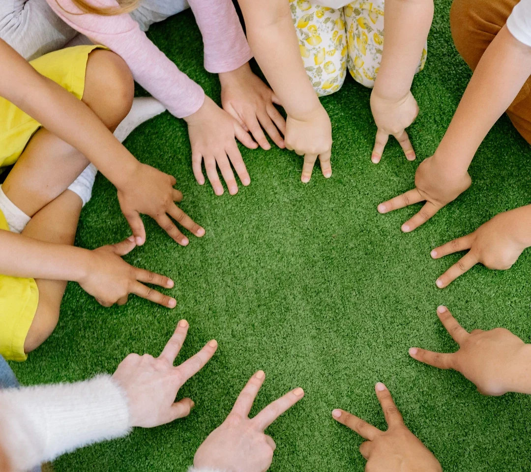 Children reaching toward each other during a group activity