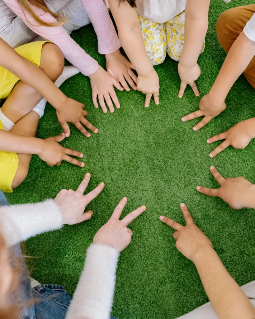 Children reaching toward each other during a group activity